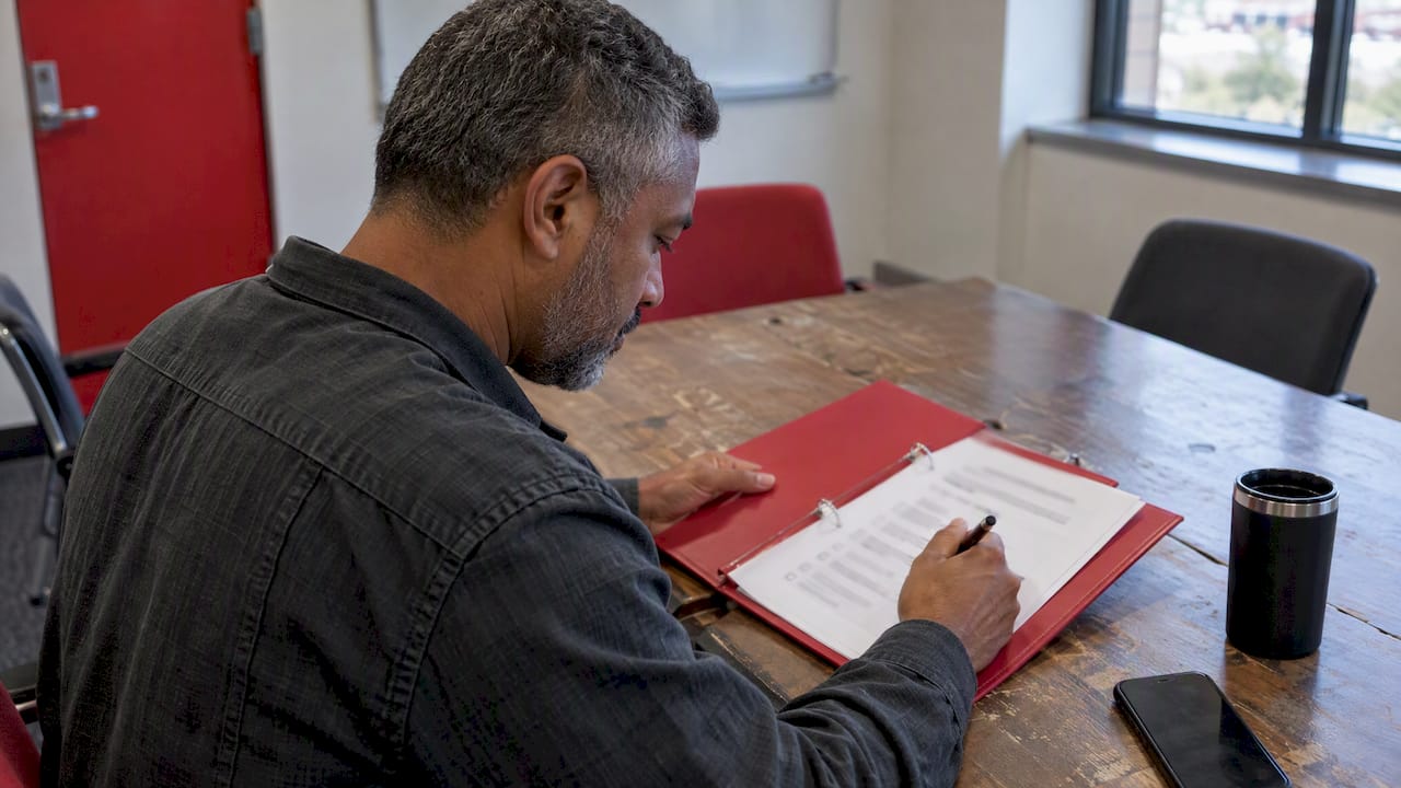 Responder checking an incident runbook checklist