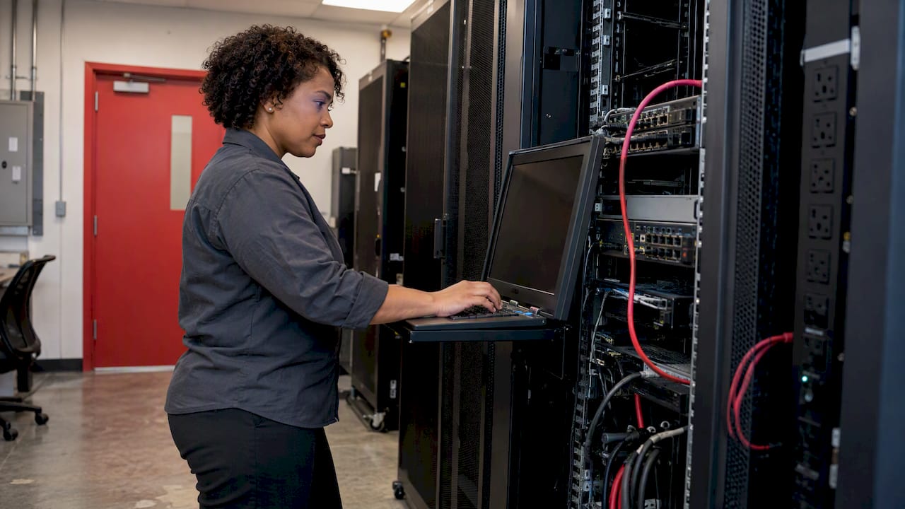 Engineer monitoring network switch and power equipment